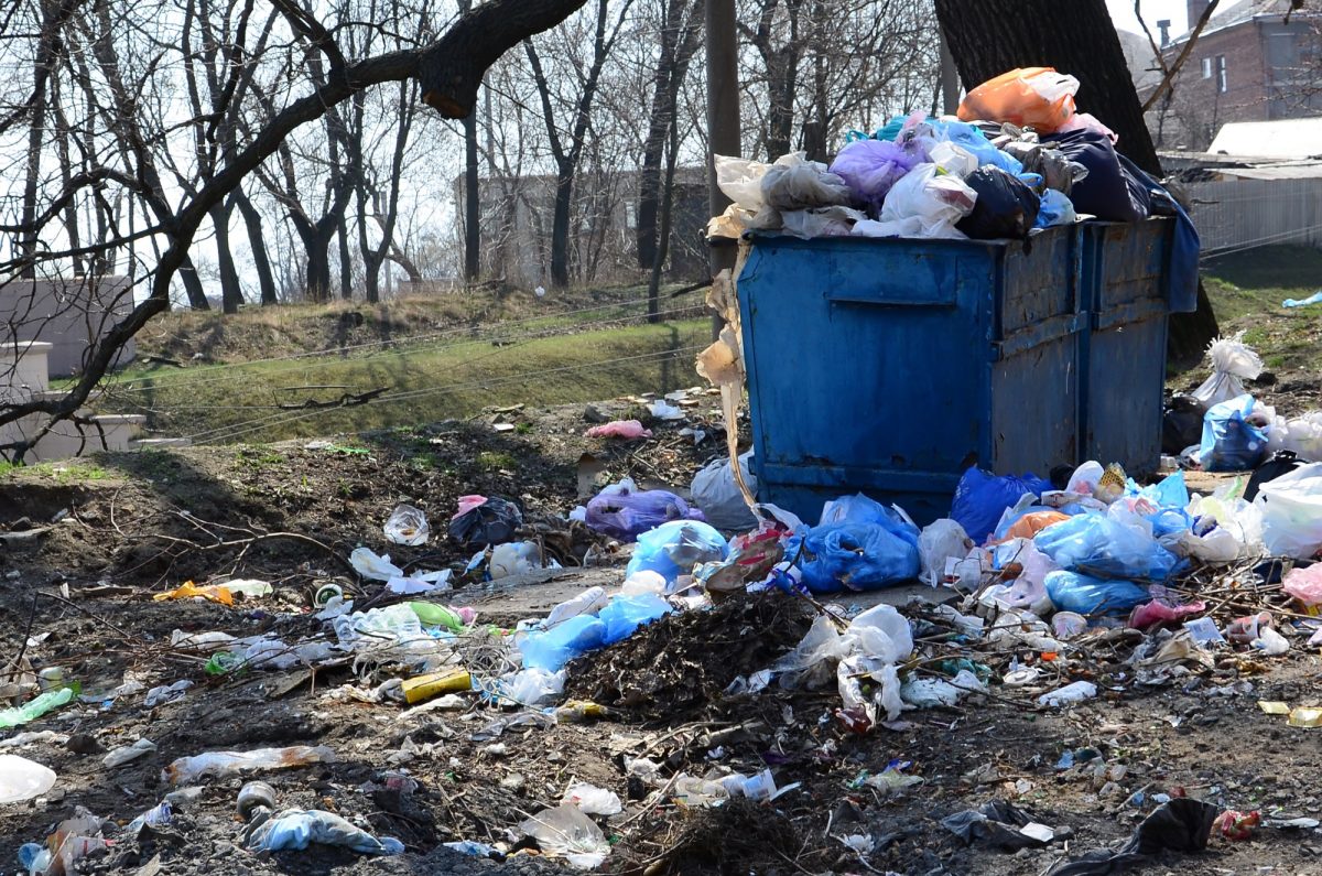 The garbage can is packed with garbage and waste. Untimely removal of garbage in populated areas